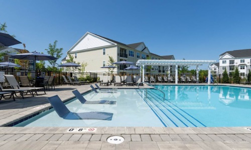 a swimming pool with chairs